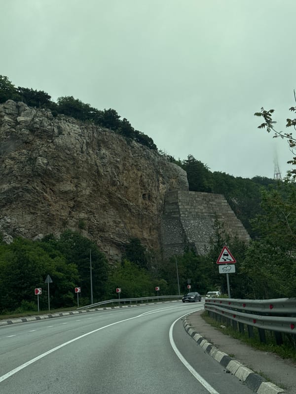 Clifftop road with guardrails observed in Crimean coastal community