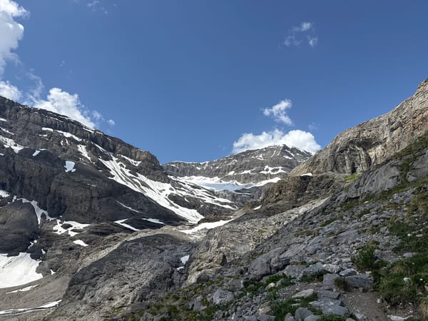 Alpine morning in Leukerbad: peaks, snow, and a braided riverbed