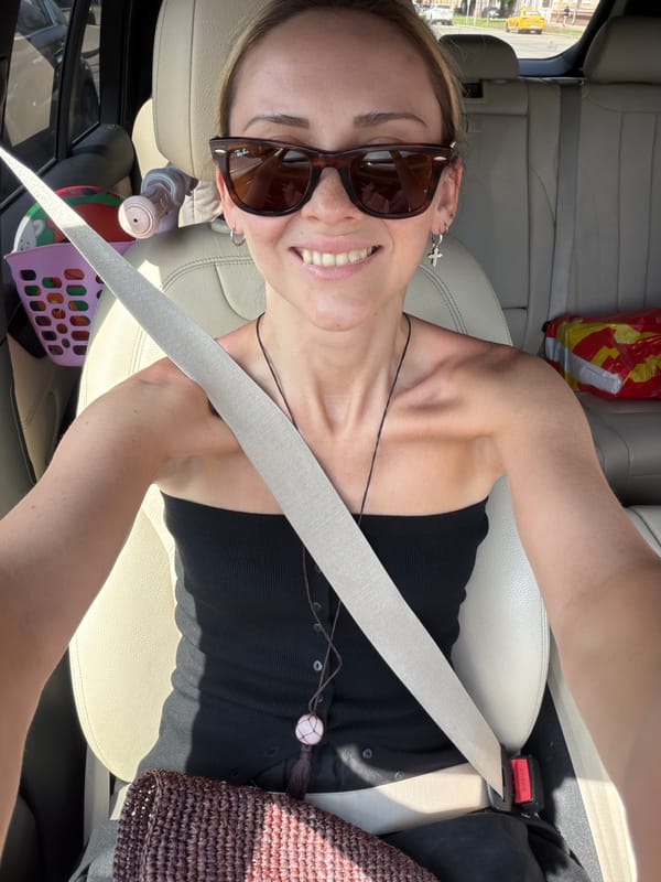 Woman takes selfie from car passenger seat in Moscow