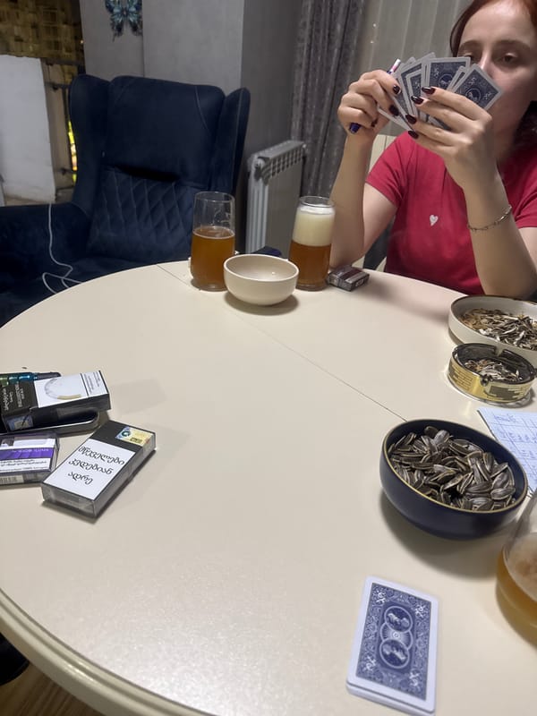 Card game and casual gathering documented in Tbilisi home