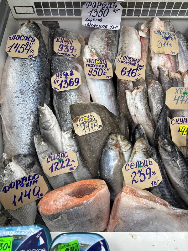 Street market scene with seafood vendors, mannequins in Izhevsk