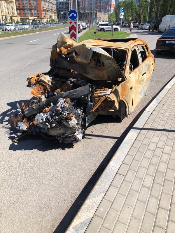 Burnt-out SUV aftermath documented on Saint Petersburg street