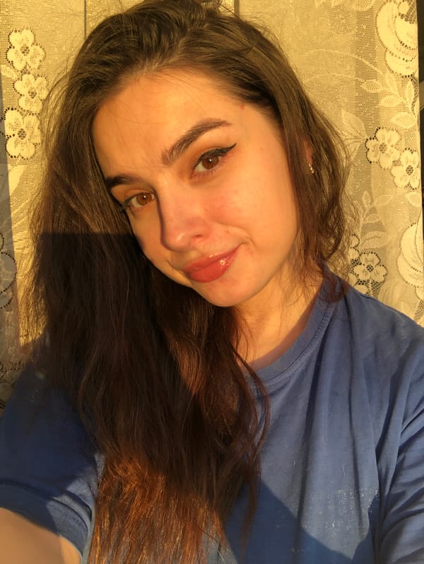 Woman creates content at home, photographing selfies and phone cases