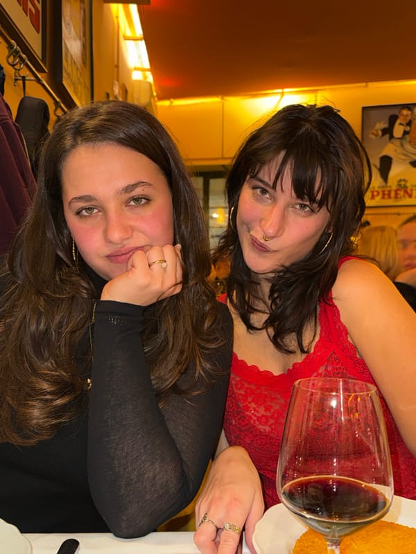Two women enjoy dinner and laughter at Milan restaurant