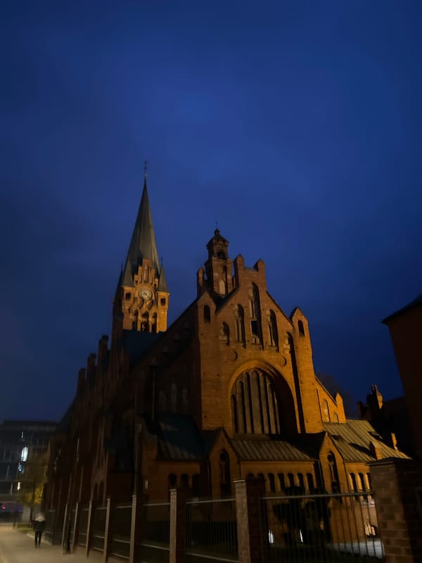 Historic church illuminated against evening sky in Bydgoszcz