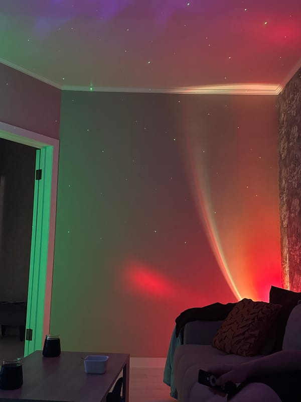 Home documented with colorful projection lighting and dining setup