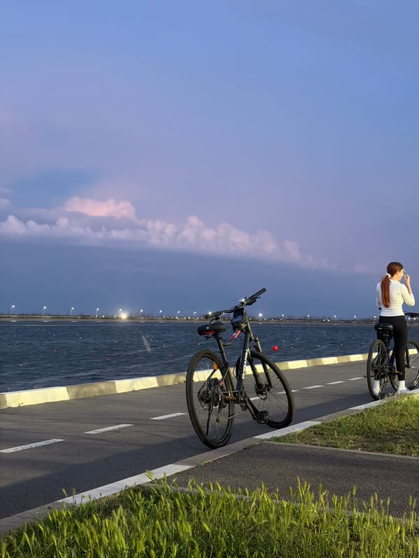 Woman with bicycles observed on waterfront path in Rostov-on-Don