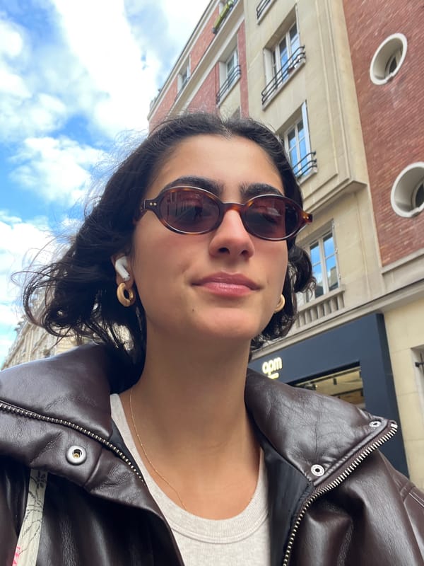 Young person takes selfie in Paris on cloudy afternoon