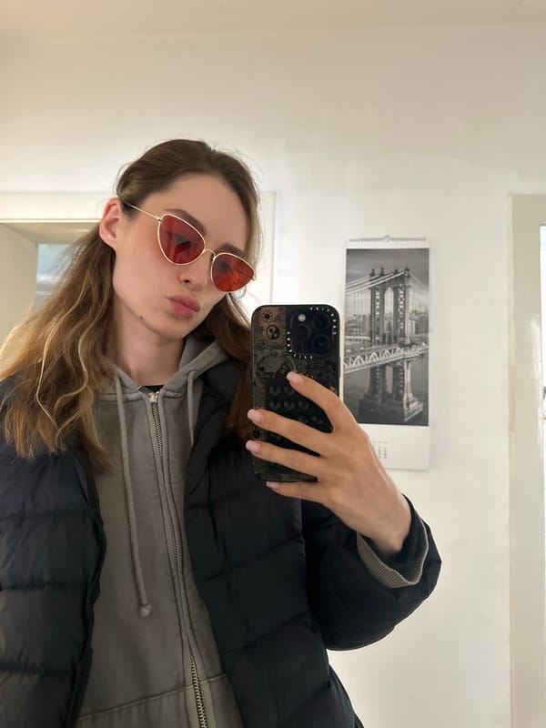 Young woman takes selfies around Kiel in grey hoodie