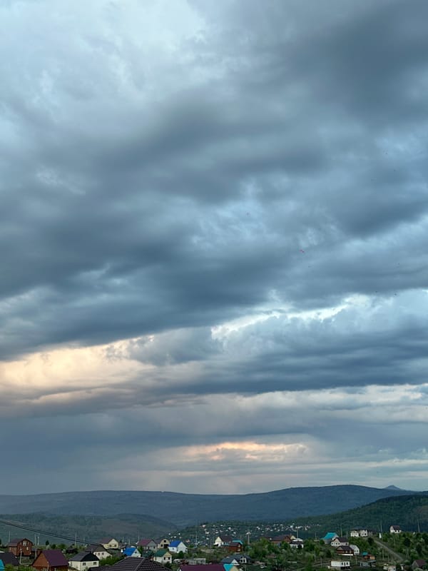 Heavy clouds with filtered sunlight observed over Gorno-Altaysk mountains
