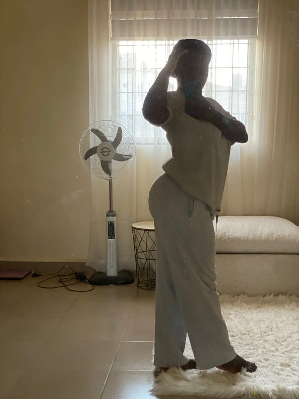Person rests on couch in Nigerian home setting