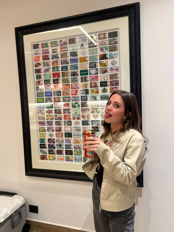 Woman poses playfully before grid artwork indoors