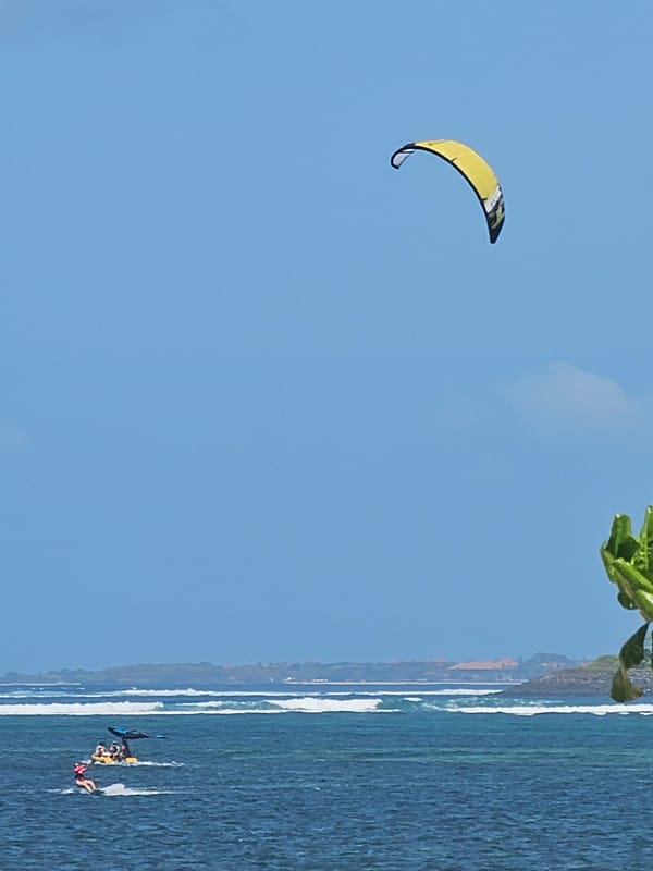 Kitesurfers hit the waves off Denpasar on a sunny morning