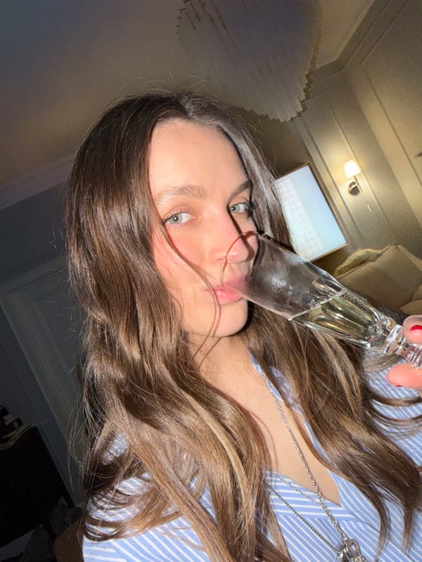 Woman hosts champagne celebration with flowers in Moscow