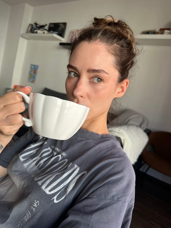 Woman in grey band shirt observed indoors in Kiel