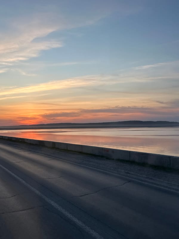 Evening scenes captured across Chaikovsky, Russia include cyclist, sunset roads