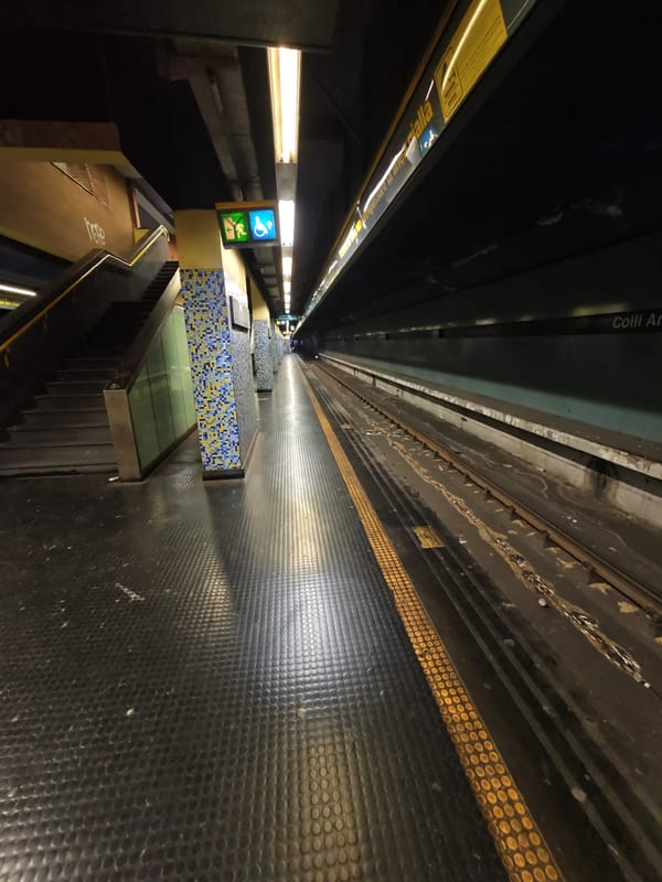 Empty Naples metro platform and tunnel, early morning.