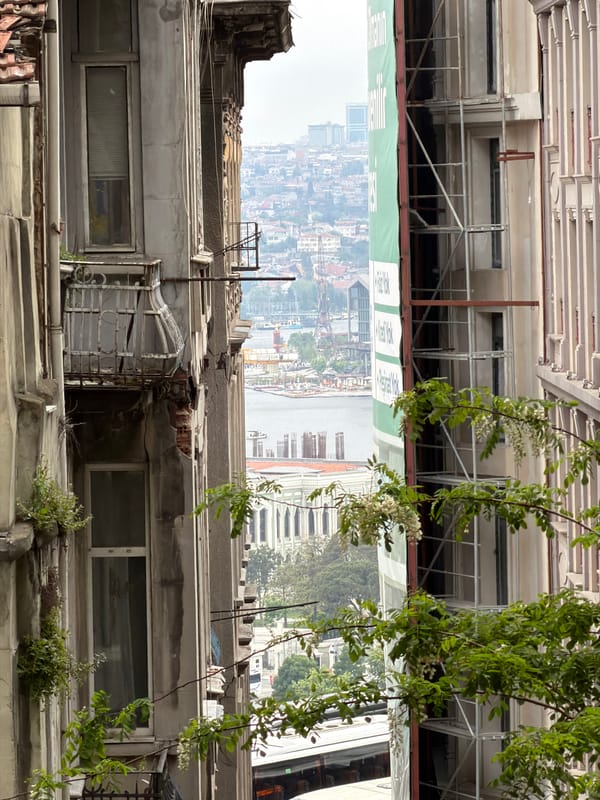 Six people gather at outdoor cafe in historic Beyoğlu district