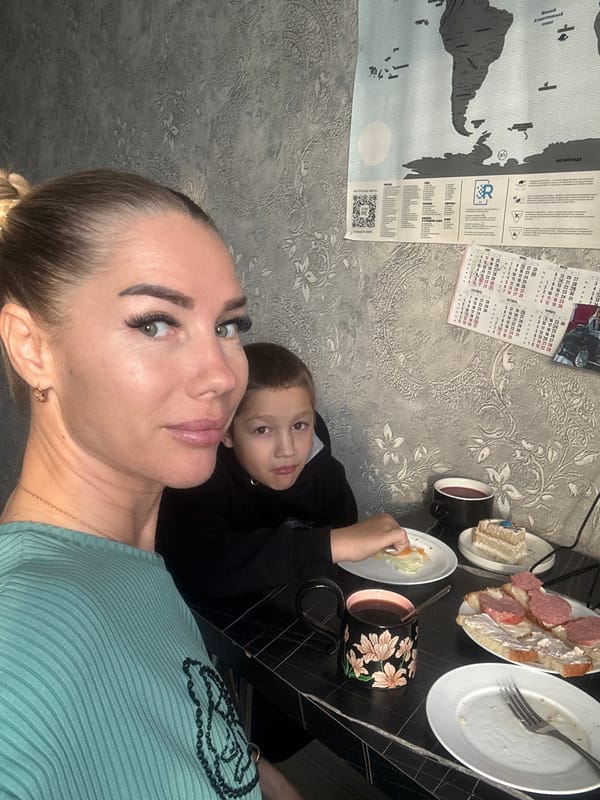 Woman takes selfies during breakfast with boy in Abakan