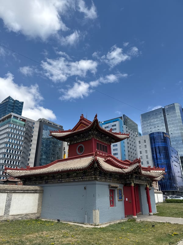 Traditional monastery documented amid modern Ulaanbaatar skyline