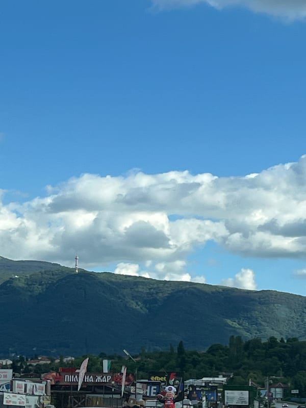 Highway drive through mountainous landscape with dramatic skies