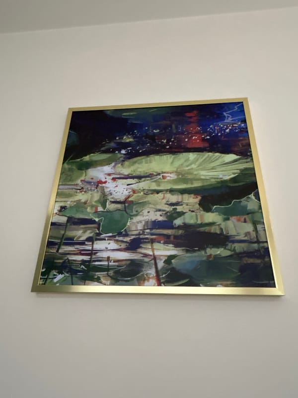 Man photographed near abstract painting in Warsaw indoor setting
