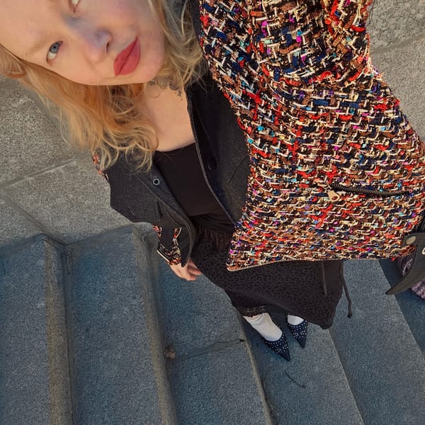 Woman sits on stone steps in Saint Petersburg