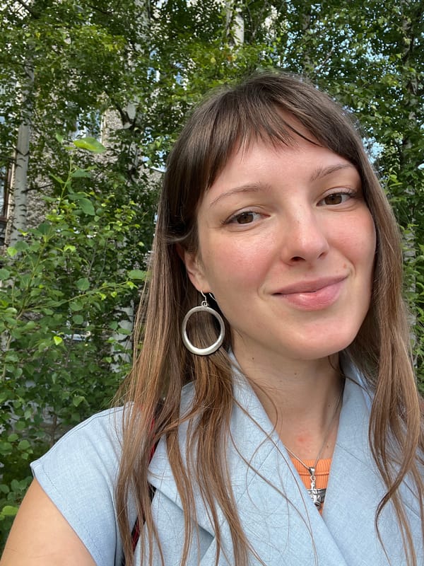 Smiling outdoors in Gubakha, Russia, light blue jacket