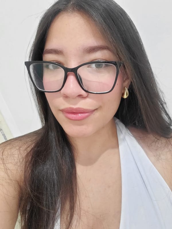 Woman in glasses, white top observed indoors in Curitiba