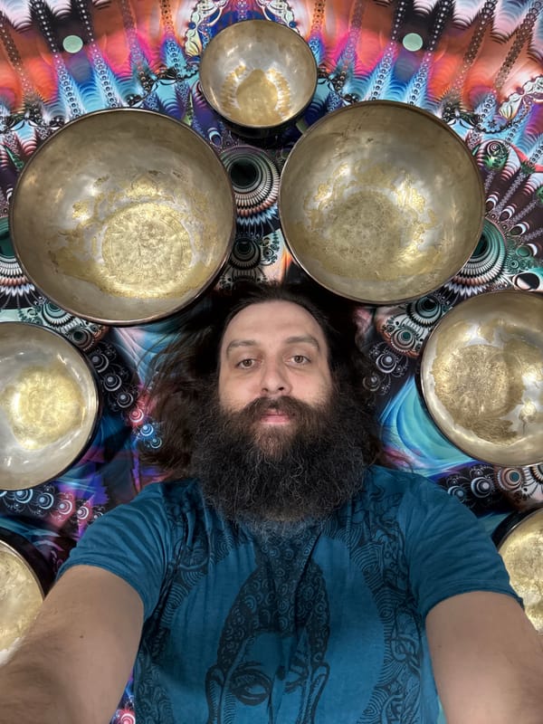 Man poses with brass singing bowls in Tashkent