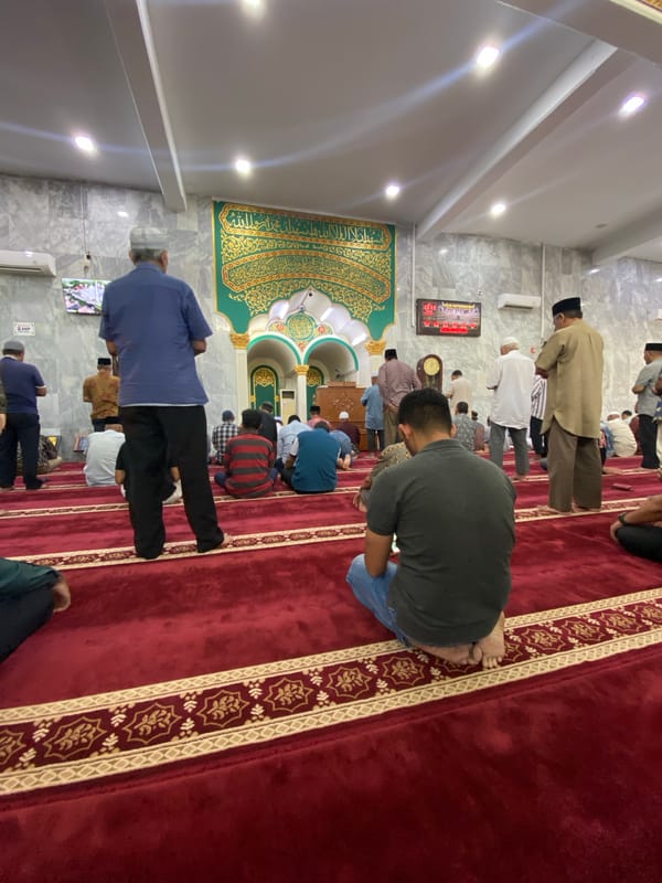 Morning congregation at prayer inside a Lhokseumawe mosque
