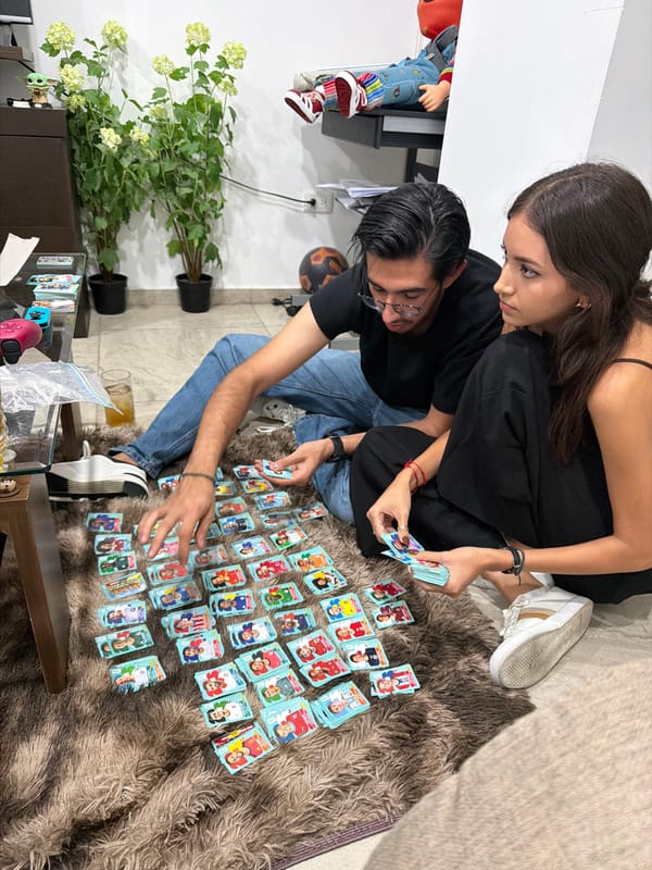 Couple sorts soccer cards, relaxes indoors in San Andrés Cholula