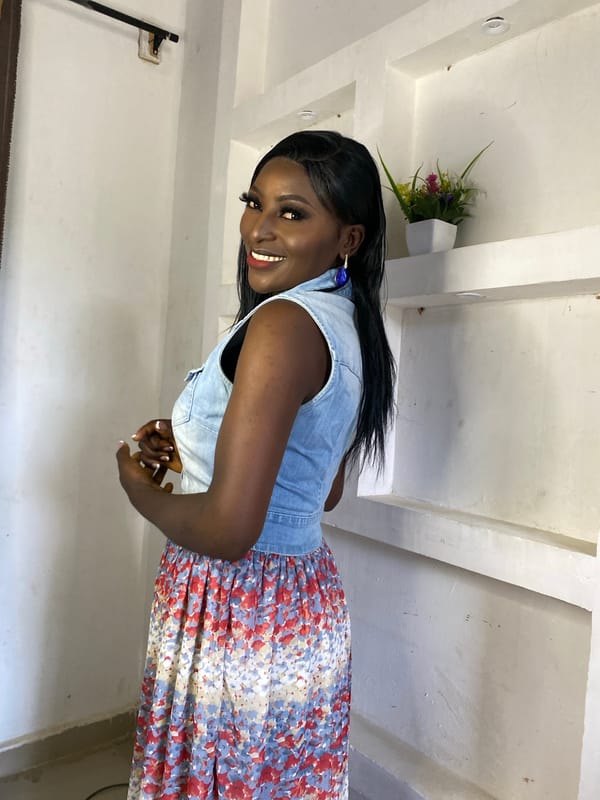Woman poses for indoor portrait session in denim and florals