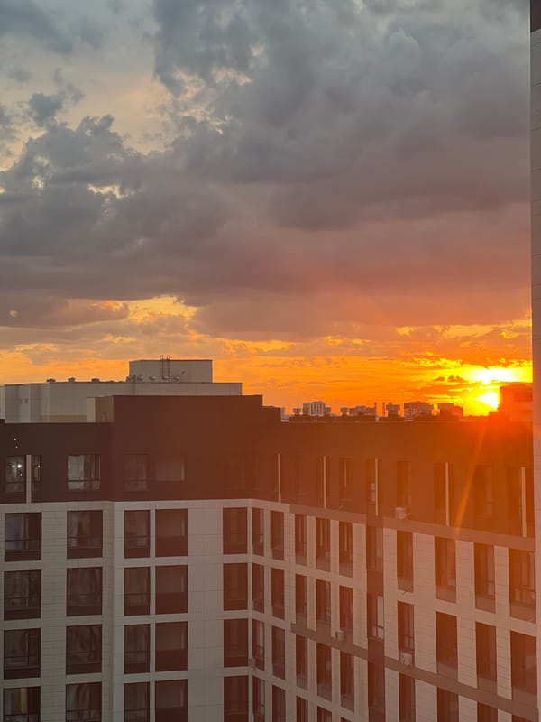 Dramatic sunset over Astana's residential skyline, June 2026