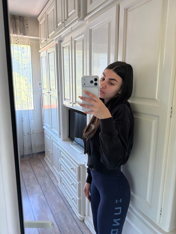 Woman takes mirror selfies in Gabrovo bathroom early morning