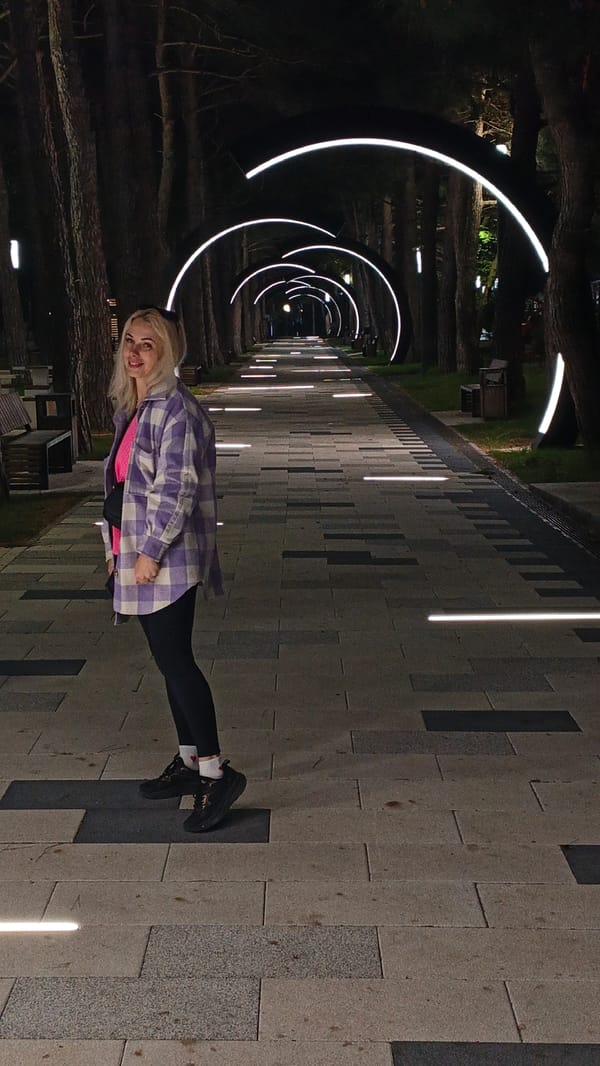 Evening stroll documented on illuminated walkway in Kabardinka