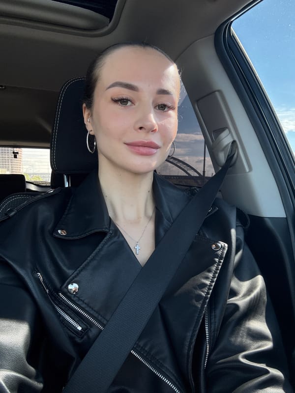 Woman drives through sunny Kyiv morning with sunroof open