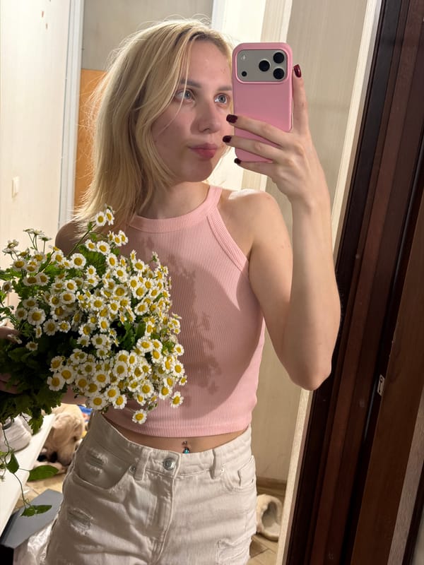 Mirror selfie with white daisy bouquet in Moldovan home