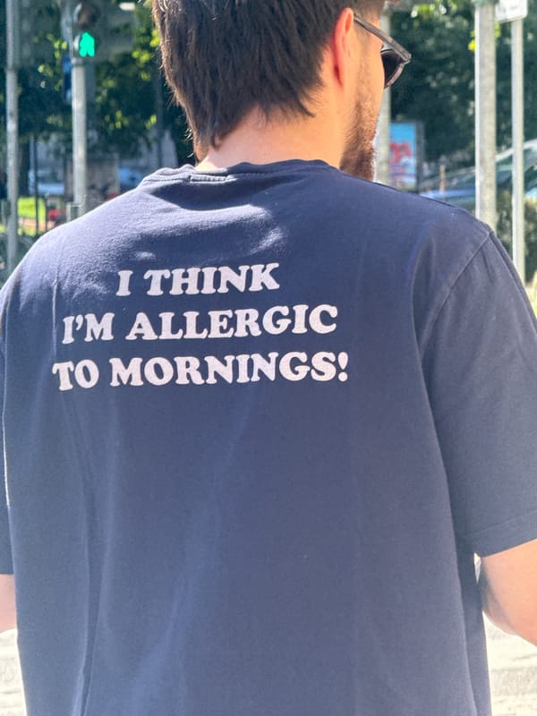 Person sports humorous morning-themed t-shirt in Milan