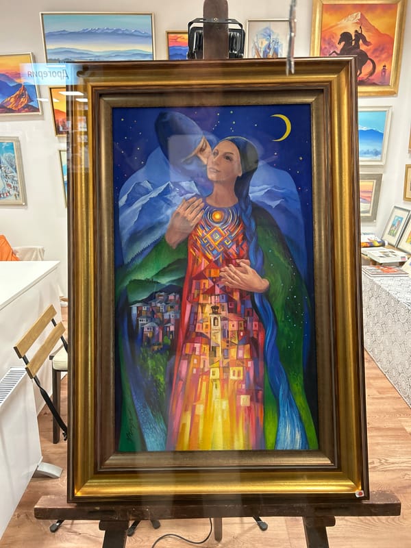 Mountain landscape painting with woman displayed on easel in Bansko