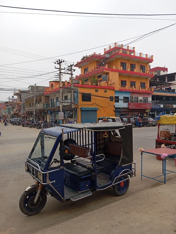 Electric rickshaw parked at Belahiya street intersection