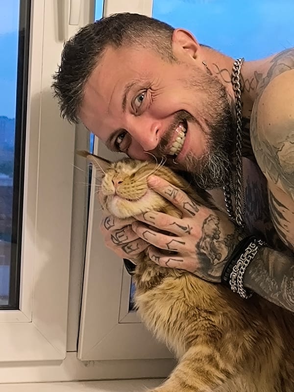 Cat cuddles by window frame in Saint Petersburg