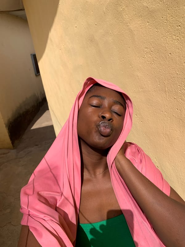 Young woman celebrates 2023 victory medal in Nigeria photo session