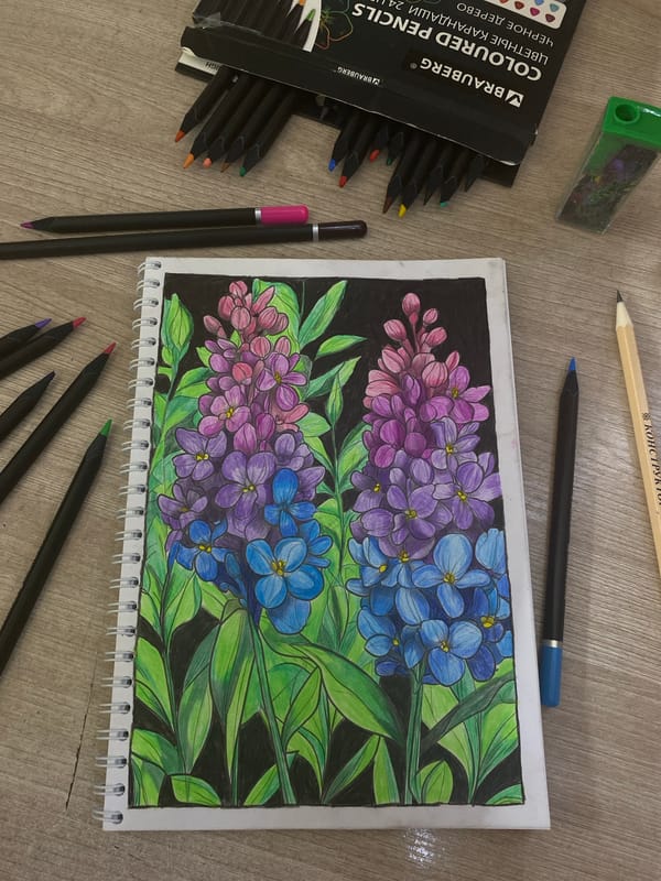 Artist sketches colorful flower stalks on wooden table surface