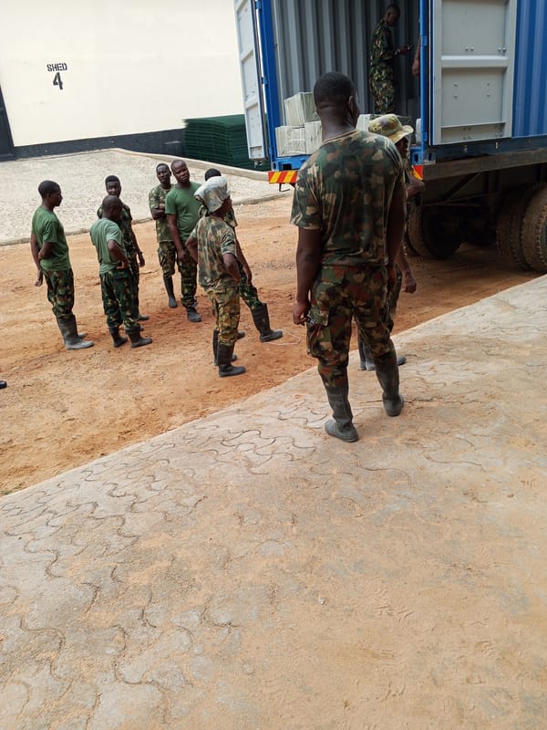 Soldiers gather in Pasere, Nigeria near shipping container