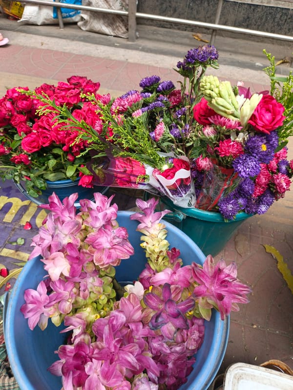 Flower vendor sells colorful blooms on Dhaka street