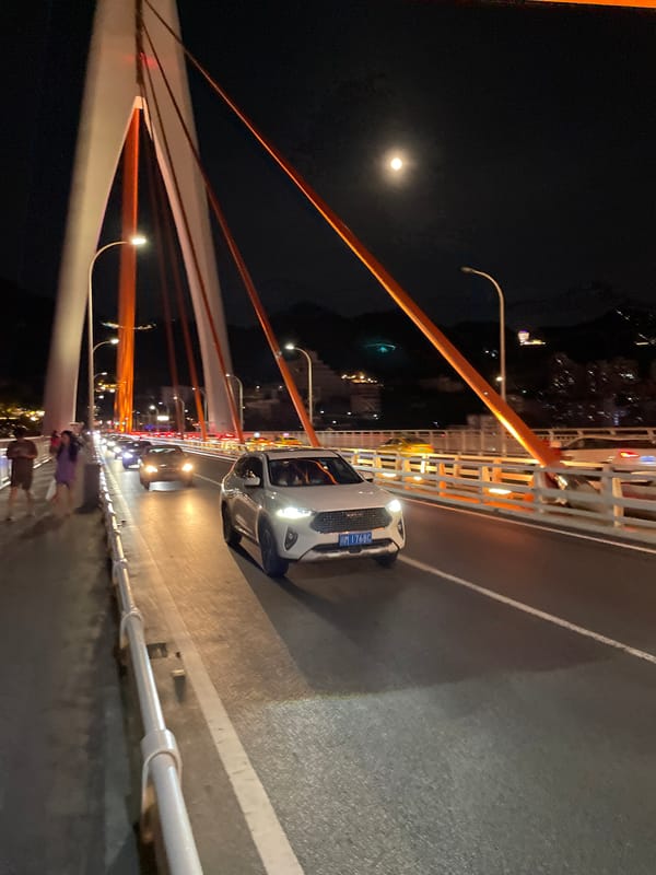 Night drive across Chongqing's river bridges, city lights in full glow