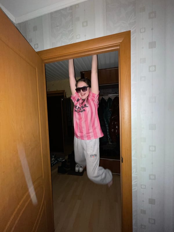 Young person strikes playful poses indoors in Murino, Russia