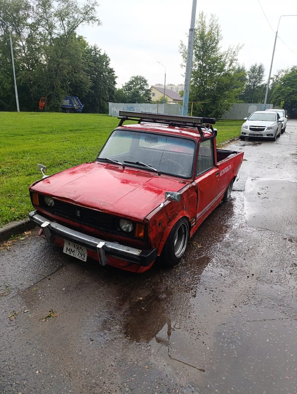 Modified red VAZ pickup spotted on wet Balashikha street