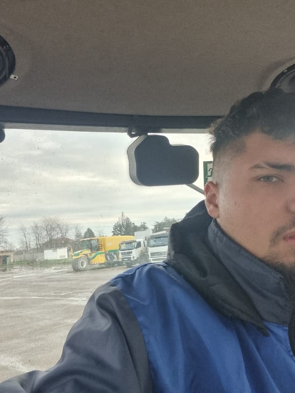 Man in vehicle cab observes trucks in Ovcharovo Bulgaria